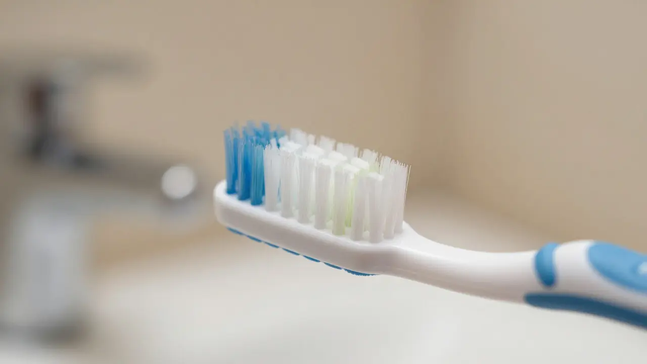 Macro shot of a toothbrush held at a 45-degree angle near the gum line